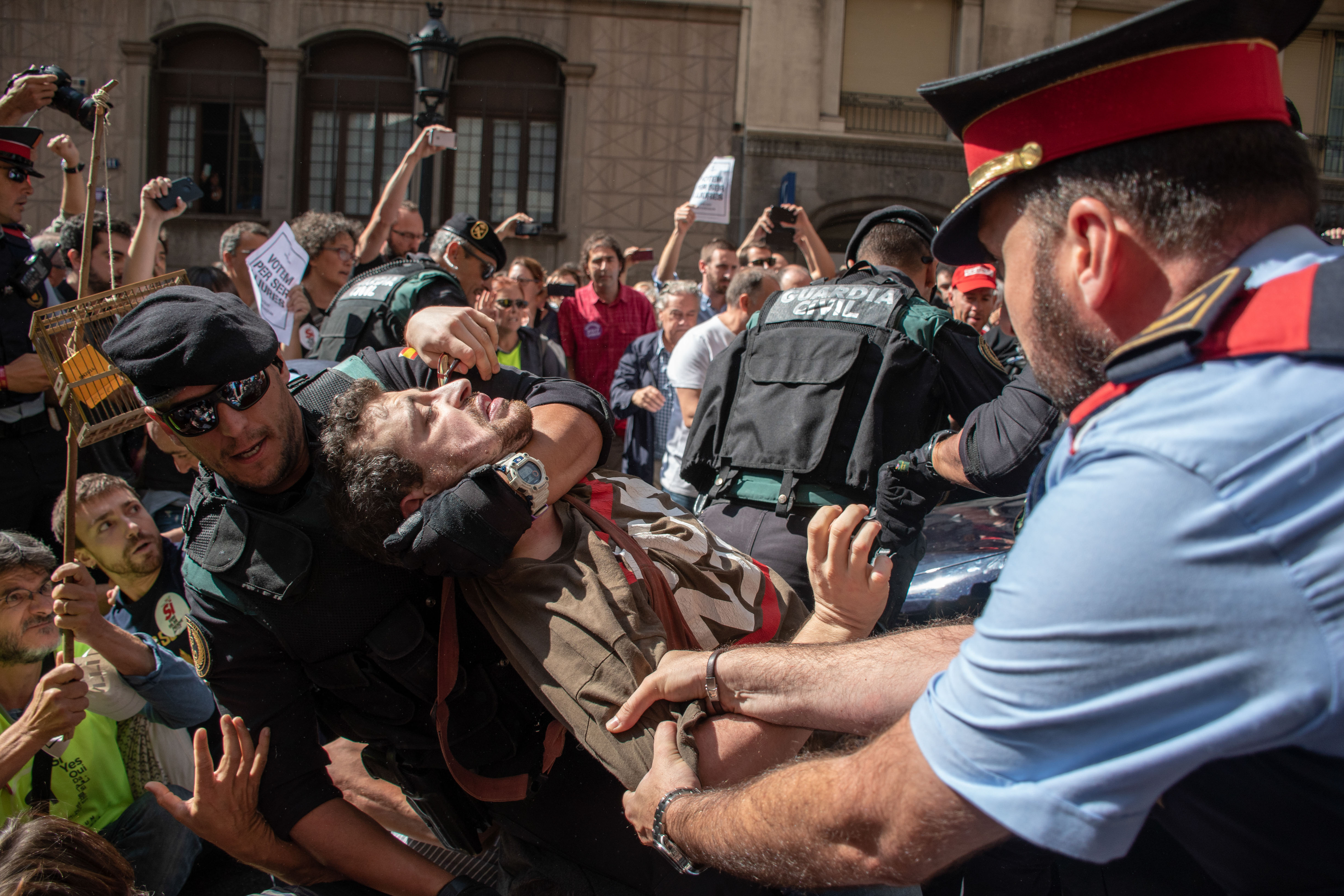 Police grab a man during a protest.