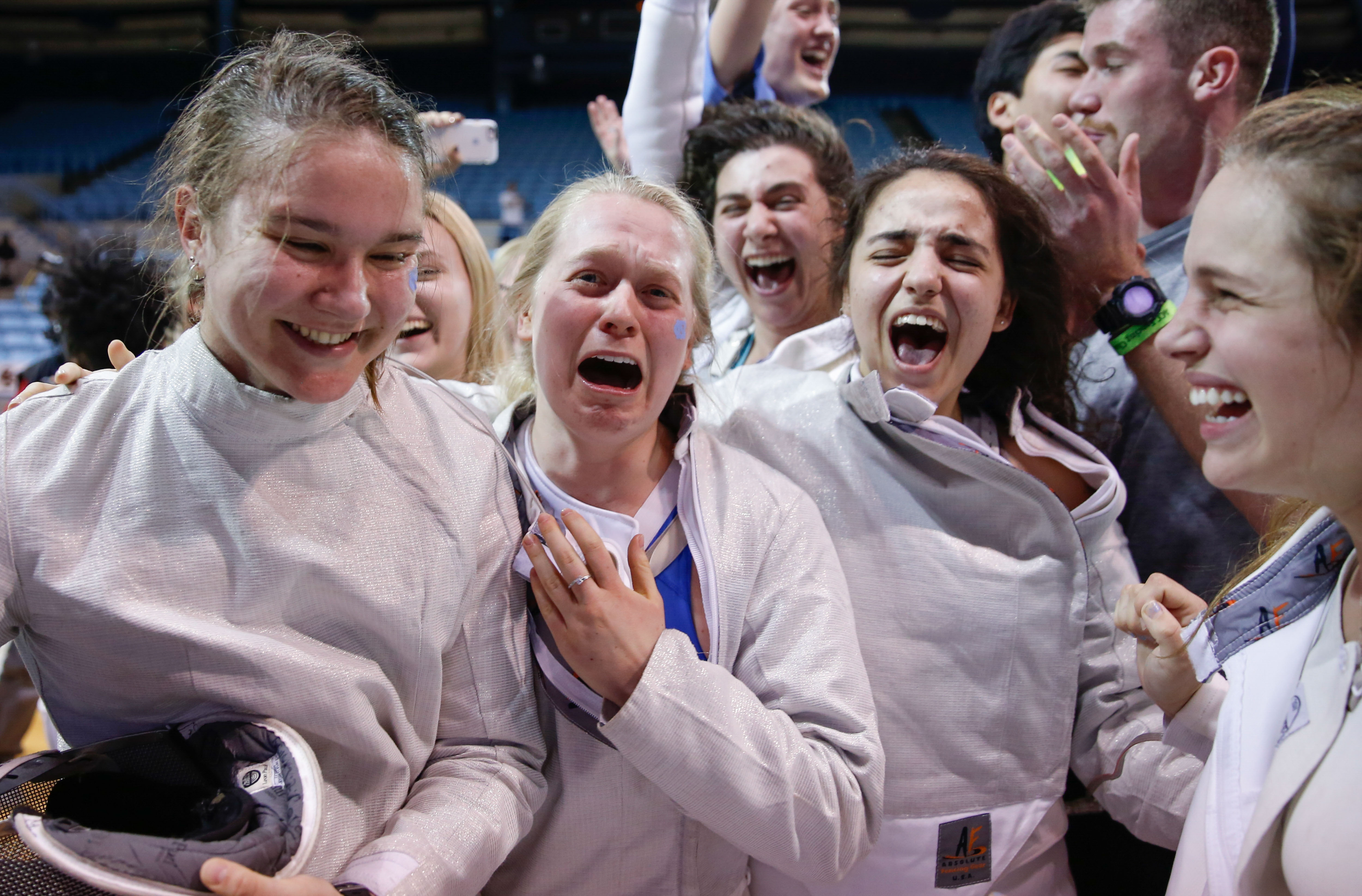 Female athletes celebrate a victory.