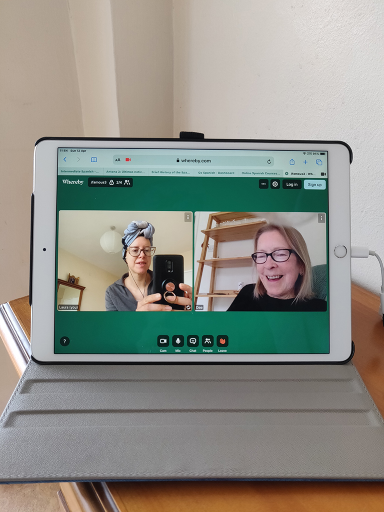 A photo of an iPad where people are talking together in a video call.