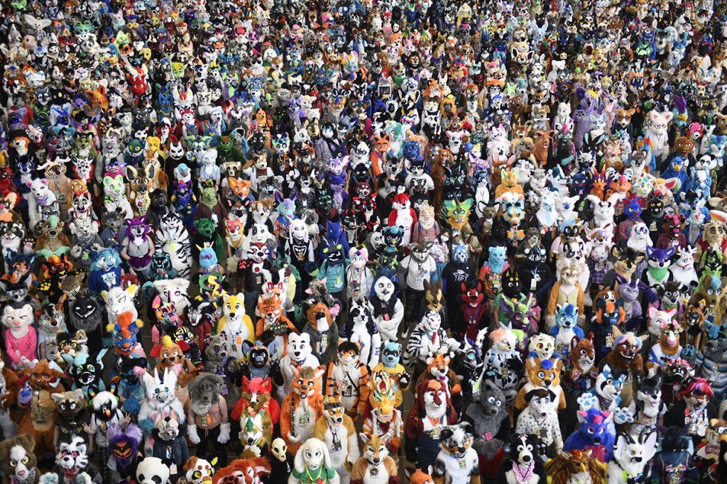 Large group of people all dressed in full body animal costumes.