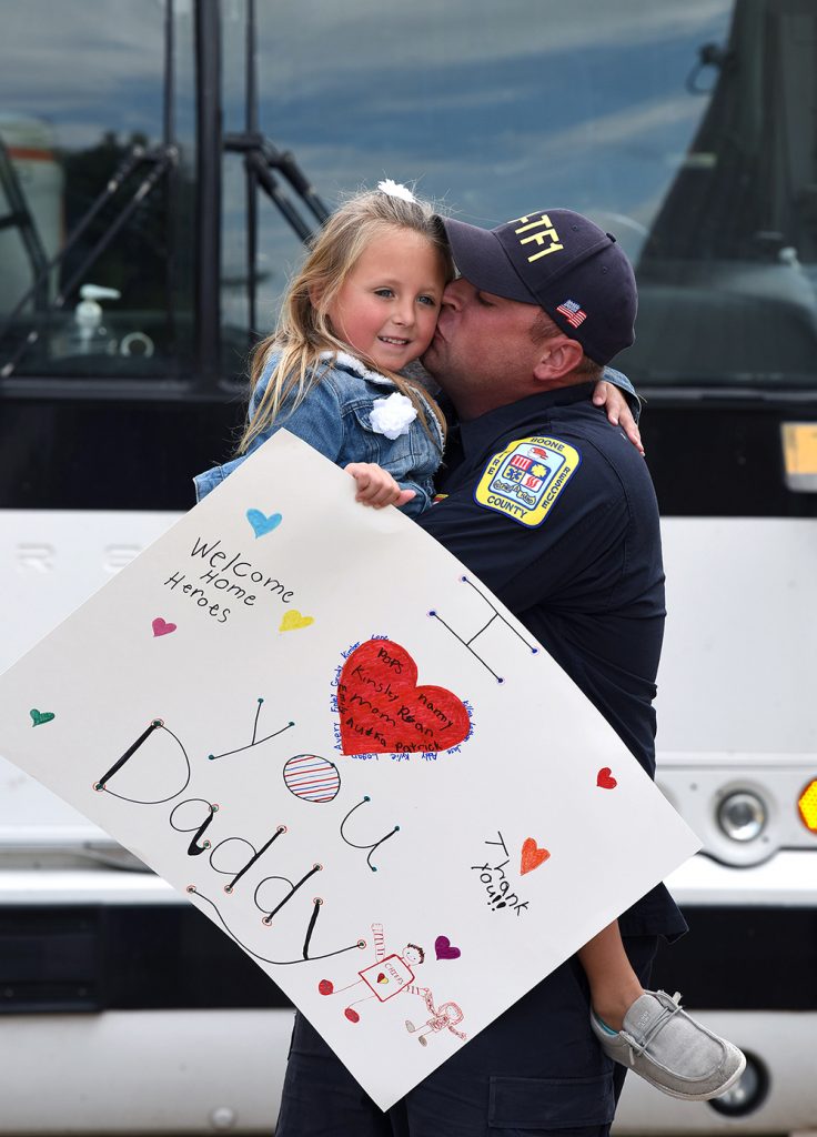 First responder hugs and kisses a child 
