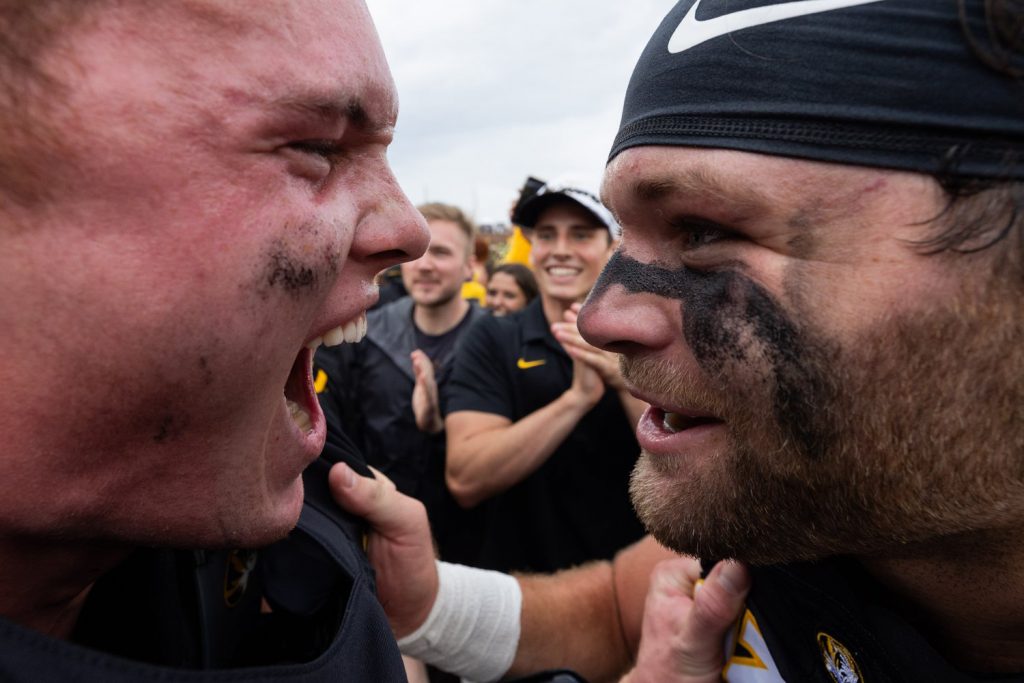 Photograph of two University of Missouri football players celebrating a victory.