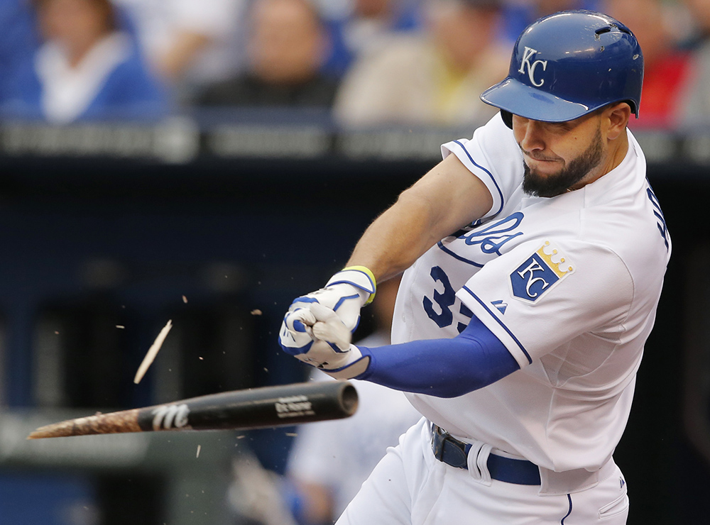 Photograph of Kansas City Royals baseball player Eric Hosmer breaking his bat as he hits a ball during a game.